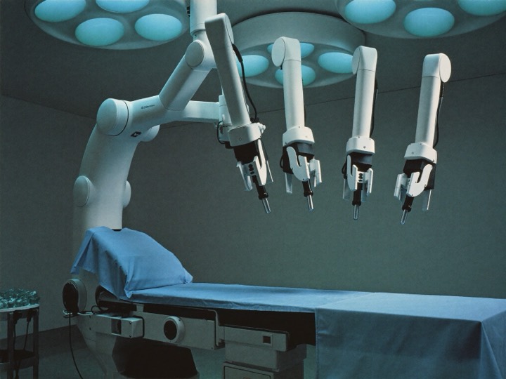 A robotic surgical system standing ready in an empty operating theatre